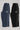 Flat lay comparison of slate and black Legacy Kids Windrunner pants, highlighting white side piping, vertical Gracie Barra branding, and the Legacy G logo on each colorway.
