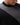 Legacy Mens Knit Sweater in black, close-up of ribbed crew neckline and tonal jacquard-knit geometric pattern showing the knit texture.