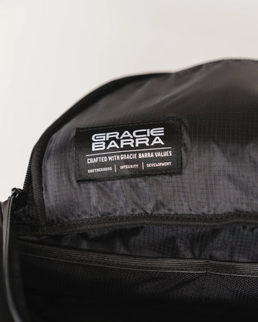 Close-up of the Legacy Travel Duffel’s interior ripstop lining featuring the woven ‘Gracie Barra’ label with the values Brotherhood, Integrity, and Development.