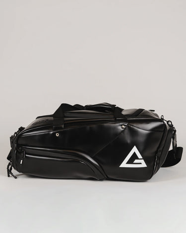 Black Legacy Travel Duffel shown from the side on a light gray background, featuring the white Legacy G logo and multiple zippered compartments.