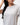 Legacy Womens Active Tee in grey, close-up of chest showing white Legacy G logo and crew neckline on lightweight performance fabric.