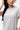 Legacy Womens Active Tee in grey, close-up of chest showing white Legacy G logo and crew neckline on lightweight performance fabric.