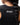 Legacy Womens Performance Racerback Tank in black, back view close-up showing racerback design and stacked Gracie Barra wordmark at upper back.