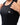 Legacy Womens Performance Racerback Tank in black, close-up of chest showing white Legacy G logo and scoop neckline on lightweight performance fabric.