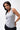 Legacy Womens Performance Racerback Tank in grey, front view on model with hand on hip, scoop neckline and white Legacy G chest logo.