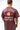 Man seen from behind in the maroon Living Legacy Boxy Tee with the Since 1986 Barra Shield and Keeping the Legacy Alive back print.