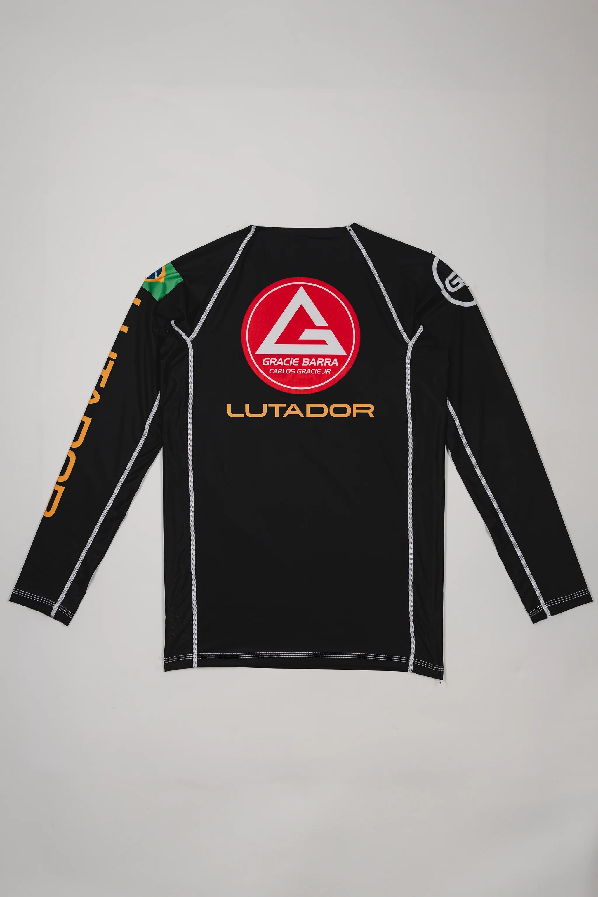 Back view of the black Lutador Longsleeve Ranked Rashguard featuring the red Gracie Barra shield, gold ‘Lutador’ text, and Brazilian flag patch on the sleeve.