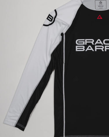 Side view of the Lutador Longsleeve Ranked Rashguard showing the full white raglan sleeve with the black GB circle logo and the black torso with Gracie Barra branding.