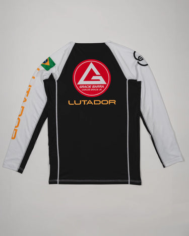 Back view of the Lutador Longsleeve Ranked Rashguard showing the large red Barra Shield, gold ‘Lutador’ text, Brazilian flag arm patch, and black-and-white paneling.