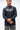 Lutador Mens Active Longsleeve Tee in navy, front view on model with arms crossed, showing white and gold Gracie Barra Lutador chest graphic.