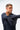 Lutador Mens Active Longsleeve Tee in navy, side view on model with arm raised across the chest, showing the fitted long sleeve and clean front.