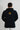 Back view of the navy Gracie Barra Lutador hoodie showing the gold G triangle logo with EQUIPE box and the Brazil flag patch on the sleeve.