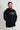 Navy Lutador hoodie worn with hands in the kangaroo pocket, showing the gold LUTADOR and EQUIPE chest graphics and standard mid-weight fit.