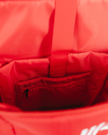 Interior view of Red GB4 Kids Backpack from Gracie Barra Red Comp Collection, showing main compartment with zip pocket, strap divider, and spacious gear storage area.