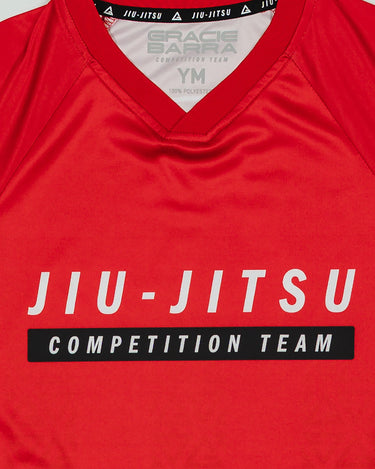 Close-up of the Kids’ Red Comp Team Jersey showing the official Jiu-Jitsu Competition Team front graphic and collar details with inner Gracie Barra branding.