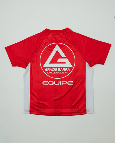 Back view of the Kids’ Red Comp Team Jersey showing the Red Shield logo, “Equipe” graphic, and tonal Legacy G pattern on a light background.
