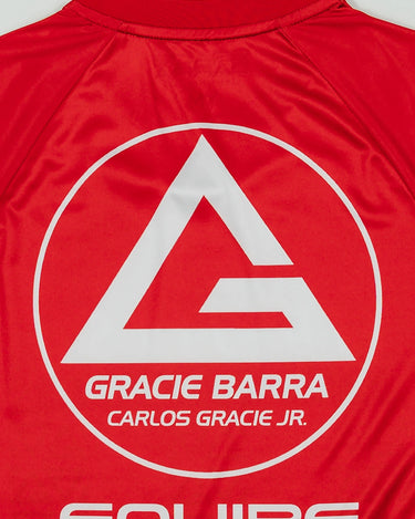 Close-up of the Kids’ Red Comp Team Jersey back showing the Red Shield logo and “Equipe” graphic on red fabric.