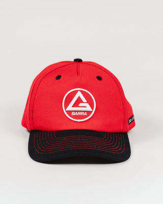 Front view of red GB Red Comp Team Cap featuring the embroidered Red Shield logo on the crown and a black brim with red stitching, shown on a light background.