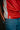 Close-up of Professor Ian wearing the Men’s Red Comp Team Jersey, showing the tonal Legacy G geometric pattern and woven Competition Team label near the hem.
