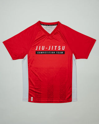 Flat-lay of the Men’s Red Comp Team Jersey featuring the official Jiu-Jitsu Competition Team graphic and tonal Legacy G pattern on a light background.