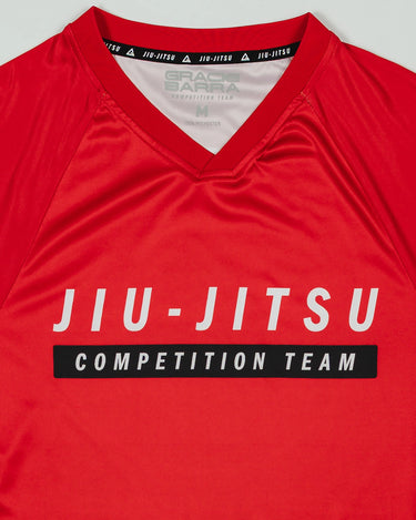 Close-up of the Men’s Red Comp Team Jersey showing the official Jiu-Jitsu Competition Team front graphic and ribbed V-neck collar with interior GB trim.
