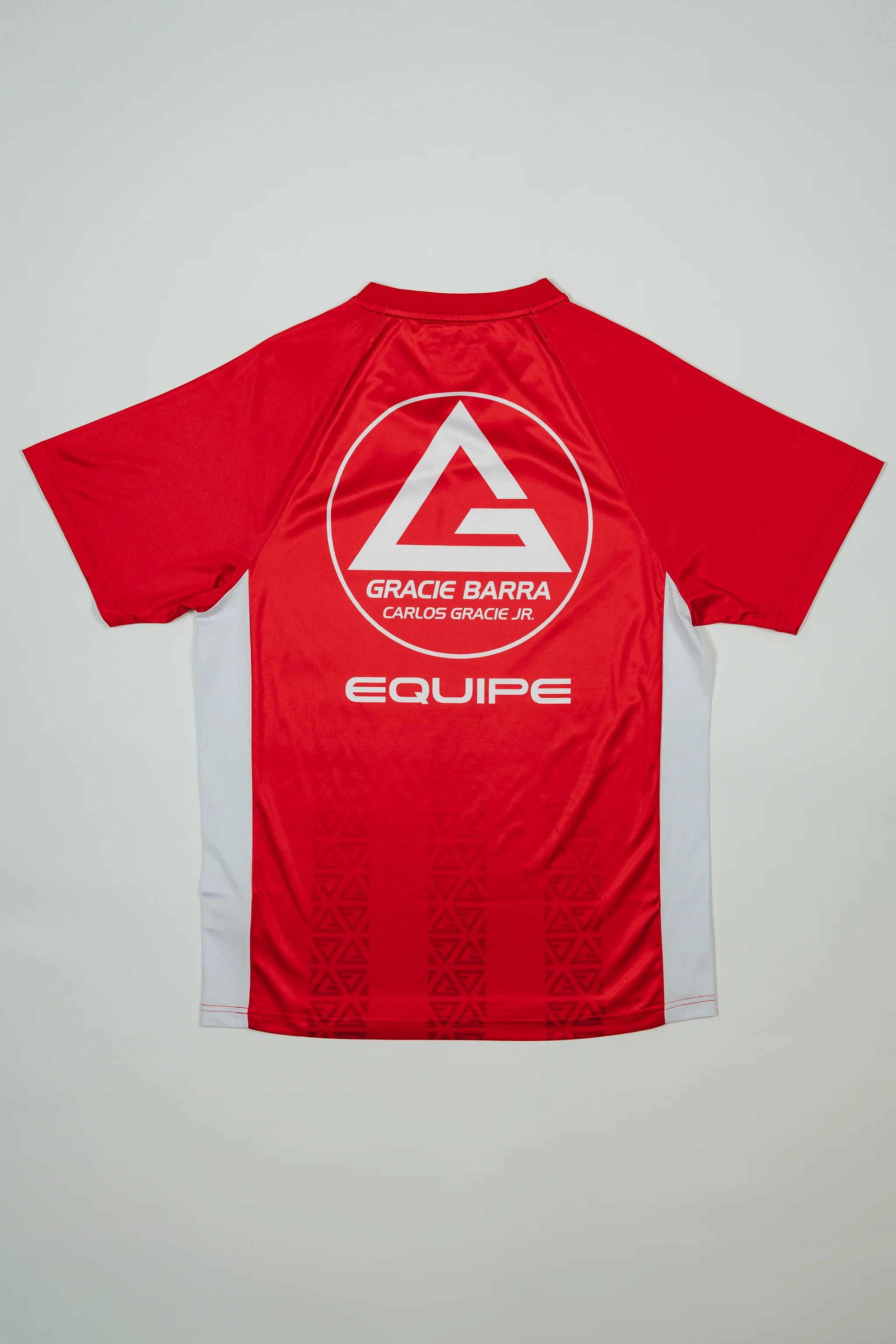 Back view of the Men’s Red Comp Team Jersey featuring the Gracie Barra red shield logo, “Equipe” text, and tonal Legacy G geometric pattern on a light background.