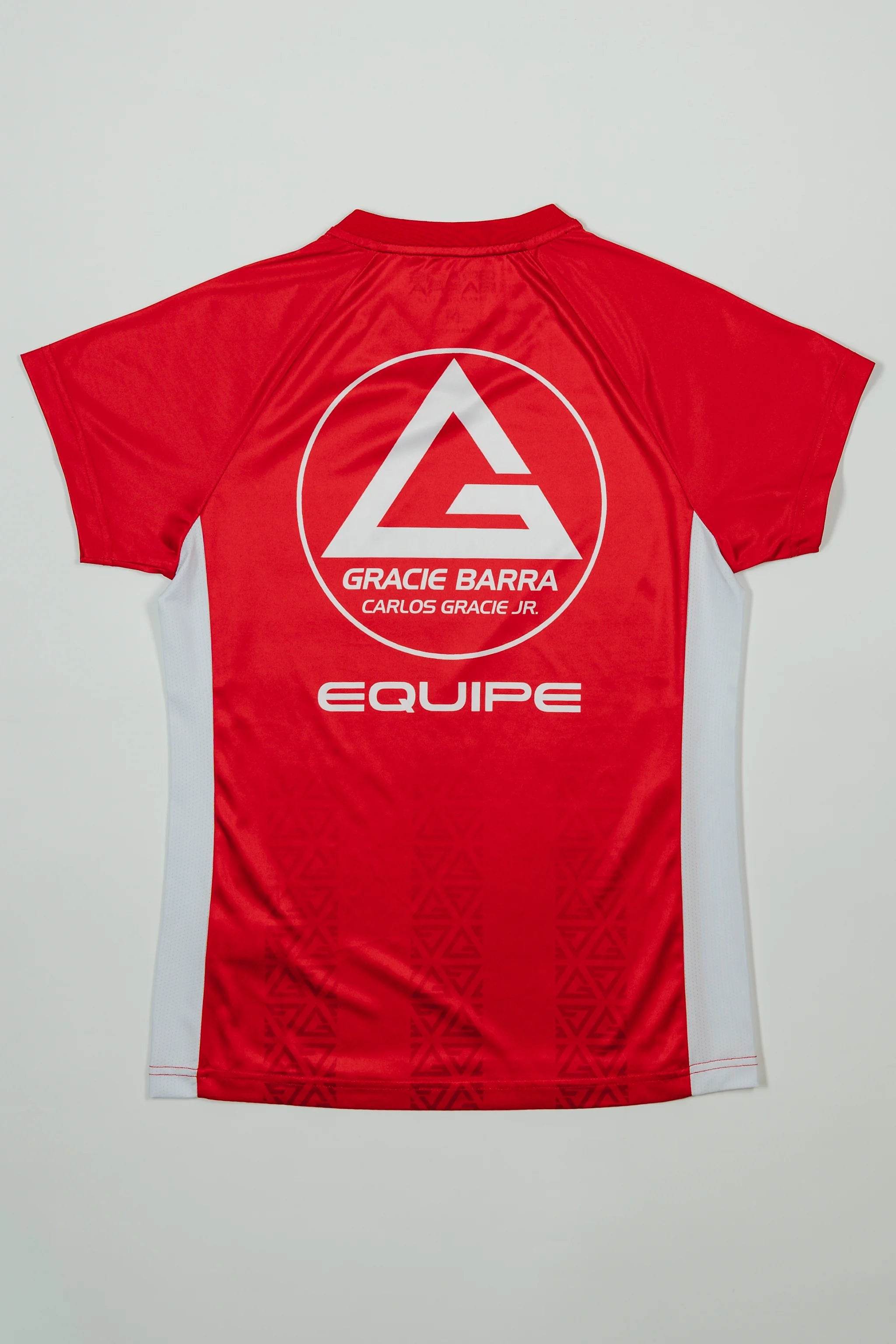 Back view of Red Comp Women’s Team Jersey featuring the Gracie Barra Red Shield, “Equipe” graphic, and tonal GB Red pattern on a light background.