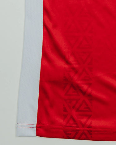 Close-up of Red Comp Women’s Team Jersey highlighting the tonal Legacy G geometric pattern and white side mesh panel.