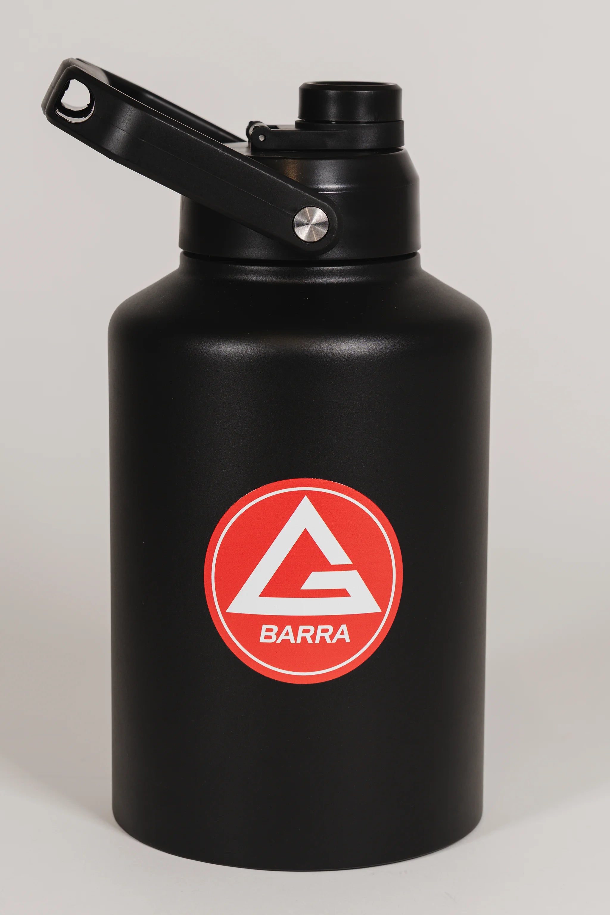 Black stainless steel 128 oz Red Shield bottle with the Gracie Barra Barra Red Shield logo on the front, photographed against a light background.
