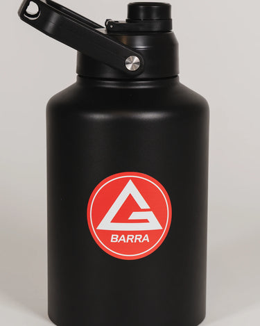Black stainless steel 128 oz Red Shield bottle with the Gracie Barra Barra Red Shield logo on the front, photographed against a light background.