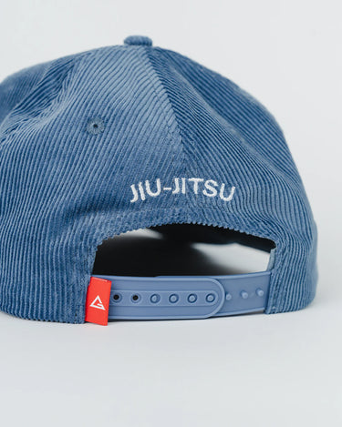 Rear view of the Red Shield Elite Cap with white embroidered “Jiu-Jitsu” text and adjustable snapback, featuring red Legacy G tag.