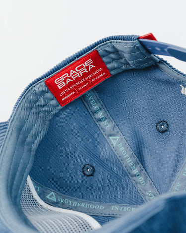 Interior view of the Red Shield Elite Corduroy Cap showing red Gracie Barra woven label and taping printed with “Brotherhood, Integrity, Development” and Legacy G logos.