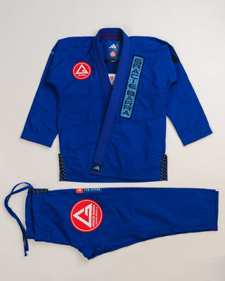 Blue Ripstop Lite Men’s BJJ kimono set by adidas and Gracie Barra, featuring military-grade ripstop jacket and drawstring pants with embroidered Red Shield patches.