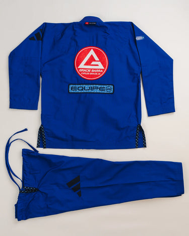 Back view of blue Ripstop Lite Men’s BJJ kimono by adidas and Gracie Barra, featuring large Red Shield patch, “Equipe GB” embroidery, and matching drawstring pants with black adidas logo.