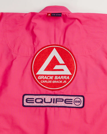 Close-up of back panel on pink Ripstop Lite Women’s BJJ kimono by adidas and Gracie Barra, showing large Red Shield patch above “Equipe GB” embroidery.
