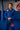 Athlete standing in a training hall wearing the full blue Ripstop Lightweight Kimono jacket and pants with a black belt and Gracie Barra chest and thigh patches