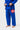 Lower front of the blue Gracie Barra Ripstop Lightweight Kimono showing the red Barra Shield on the pant thigh, jacket skirt and red hem stitching.