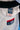 Close-up of the white ripstop kimono jacket's shoulder and lapel with a black belt draped over it, showing the navy GB woven label, red contrast stitching, and red Gracie Barra Jiu-Jitsu chest patch