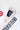 Close-up of the white ripstop kimono collar and lapel, showing red contrast stitching, the navy GB Gracie Barra Jiu-Jitsu woven neck label and embroidered chest patch