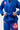 Student tying the blue belt on the Ripstop Lightweight womens kimono, with Gracie Barra lapel patch, Barra Shield and red pants patch