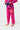 Lower front of the pink Ripstop Lite Womens Kimono by adidas showing the red Barra Shield pant patch and purple patterned trim on the jacket skirt.