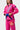 Angled detail of the pink Gracie Barra Ripstop Lite Womens Kimono by adidas with the Gracie Barra lapel patch and red Barra Shield pant patch.