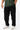 Ripstop Utility Pants in Black — front view on model from the waist down, showing the straight tapered leg worn with white sneakers.