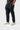 Back of the black Ripstop Utility Pants on a student, showing the seat seam, welt back pockets and cuffed hem.
