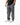 Ripstop Utility Pants in Gray — angled back view on model with hand in pocket, showing the tonal Gracie Barra embroidery and red-stitched pocket.