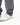 Ripstop Utility Pants in Gray — cuff close-up showing the multi-row hem stitching sitting over a white sneaker.