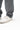 Ripstop Utility Pants in Gray — cuff close-up showing the multi-row hem stitching sitting over a white sneaker.