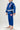 Front three-quarter view of kids model wearing Sakura V3 blue BJJ Gi with Gracie Barra lapel detail, pink Red Shield logos, and Sakura embroidery on pants.