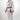 Front angle view of female athlete wearing the Sakura V3 Women’s Kimono in white with purple Sakura embroidery, Red Shield logo, and brown belt on white background