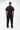 Stacked Button Up in Black — full back view on model showing the clean back yoke and curved hem of the short-sleeve button-up.
